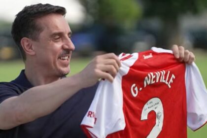 Arsenal chief Josh Kroenke sends three-word message to Gary Neville with title gift